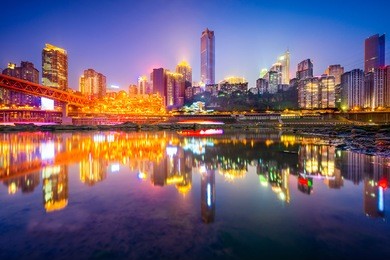 chongqing, china riverside cityscape at night on the jialing river.