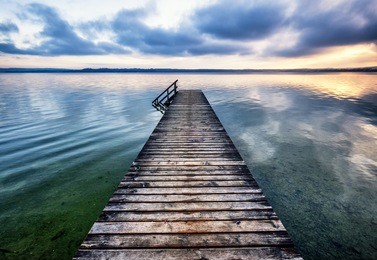 old wooden jetty at the chiemsee lake in bavaria