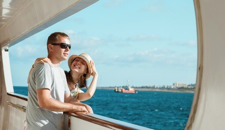 young couple standing on board the ship