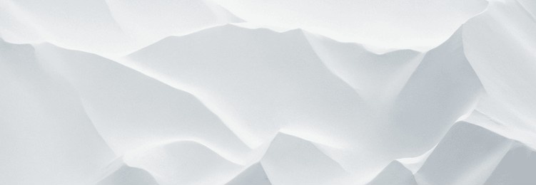 close-up abstract image of white snow drifts with subtle shadows. premium white background with beautiful texture for banner and poster background.