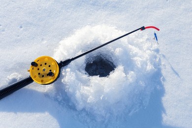  fishing rod for ice fishing on snow near hole. winter fishing on ice.