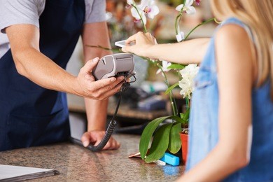 mobile payment with smartphone at checkout in nursery retail store
