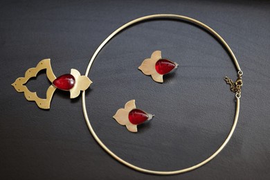 product photography of persian handmaid jewelry containing necklace, earrings, and rings 