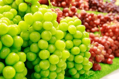 shine muscat grape, closeup, behind red grapes, sale on the shelf