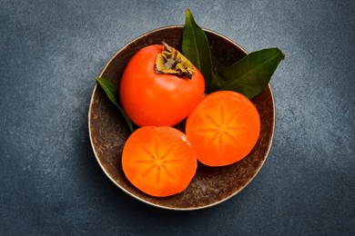 close up, sliced ​​persimmon fruits in a bowl. top view.