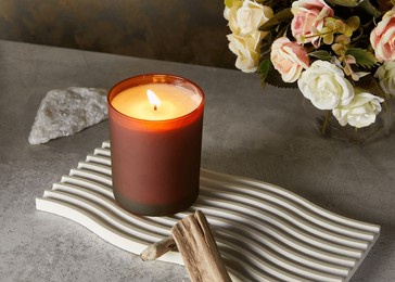 scented candle in a minimalistic composition on the background of the interior of the room