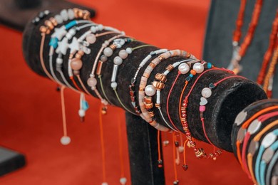 a close-up of a luxury jewelry set, including a silver bracelet, bangle, and gemstone necklace, reflecting intricate craftsmanship and artistic beauty.