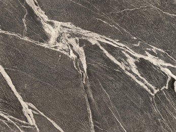 natural black marble with white veins pattern in rough textured finishes, black honed marble with diagonal white veining, rough stone texture. seamless pattern.