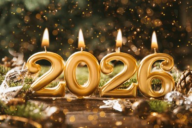 holiday background happy new year 2026. numbers of year 2026 made by gold burning candles on bokeh festive sparkling background. celebrating new year holiday, close-up. space for text