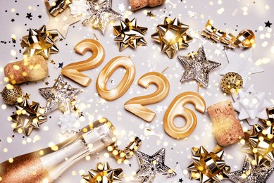 holiday background happy new year 2026. numbers of year 2026 made by gold candles on bokeh festive sparkling background. celebrating new year holiday, close-up. space for text
