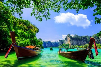 traditional longtail boat at railay beach, ao nang, thailand