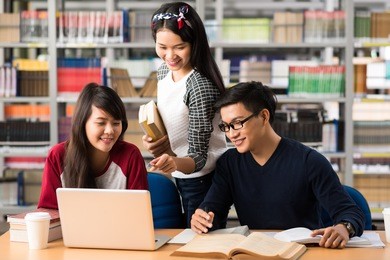 students watching something on the laptop in library