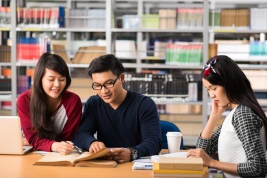 group of vietnamese college student doing homework in a library