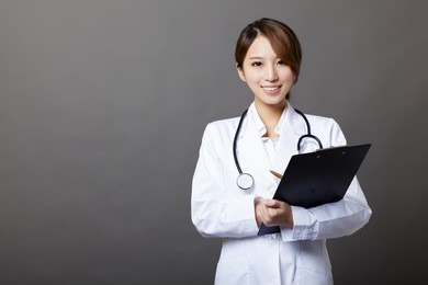 smiling female doctor with clipboard 