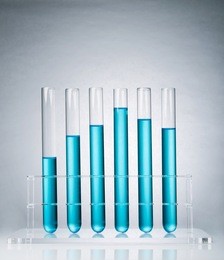 test tubes in a rack containing blue solutions