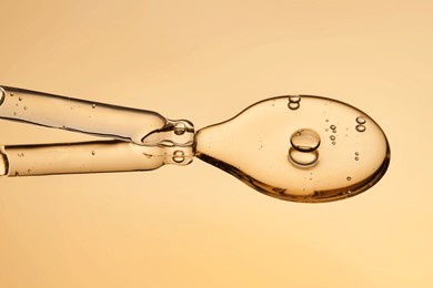 a pipette with a beautiful drop of gel-textured facial serum.