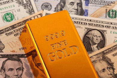 gold bars and us dollars bills