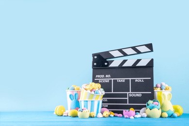 easter film and movie background. cinema clapper-board with easter chocolate egg. popcorn and marshmallow, cinema for the easter holidays and movie night party