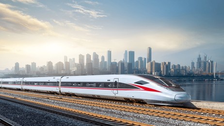 modern high-speed train against urban skyline at sunset  