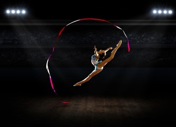 girl engaged art gymnastics at sports hall