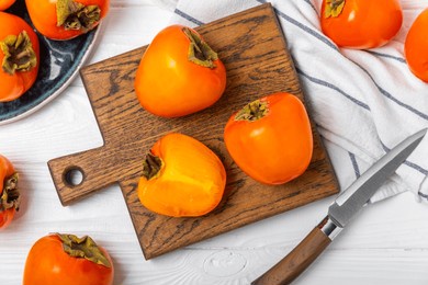 persimmon on textured wooden background. persimmon fruit. a piece of ripe, juicy, sweet persimmon fruit. vegan. orchard. close-up. space for text. copy space.