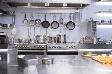interior of restaurant kitchen with professional utensils, out of focus