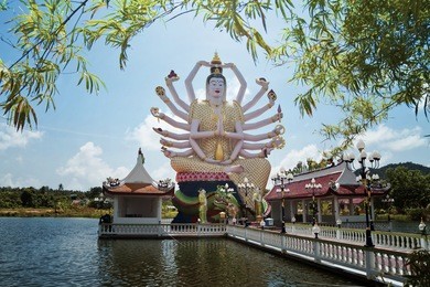18 hands god statue (guanyin) on blue sky in temple (wat plai laem),koh samui,surat thani,thailand,vintage style light