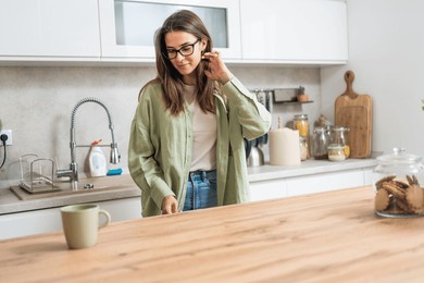 boredom. young beautiful business woman start her free days for vacation, feel bored, dont know what to do on her free time. female standing in domestic kitchen at home without idea what to do.