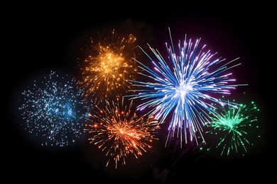 five vibrant firework bursts in night sky