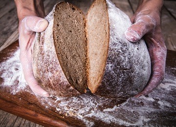 food. rye bread in male hands
