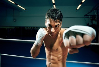 young adult man boxing in gym. copy space