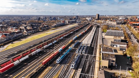 railroad, train tracks and trains aerial drone view from above, railway station in the netherlands, transportation, logistics and public transport infrastructure concept