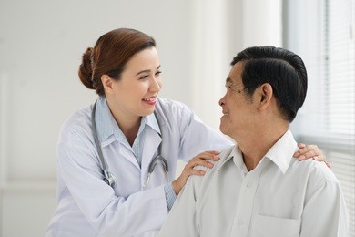 friendly doctor reassuring senior patient