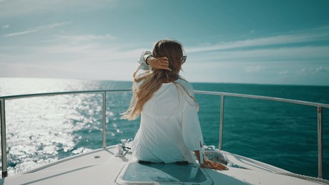 trip to ocean by yacht, back view of happy female vacationer admiring seaview. summer vacation, touristic excursion, fishing in open sea, woman looking to horizon, rearview, freedom and joy in summer