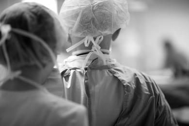 back view of surgeons in uniform, monochrome