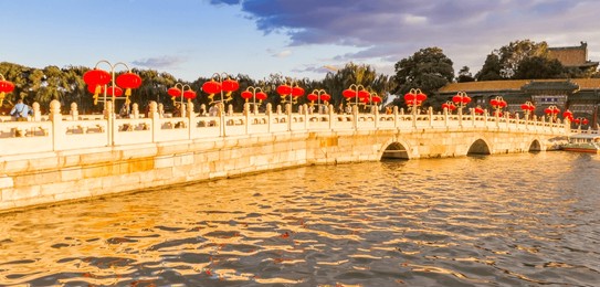 panorama of afternoon light over the yongan bridge in beihai park in beijing, china