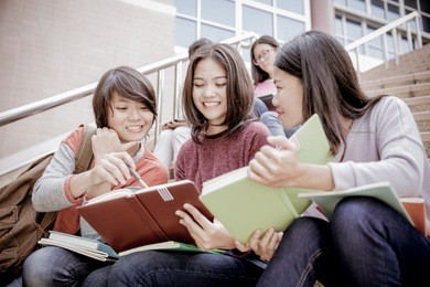 group of happy teen high school students outdoors