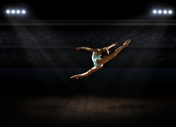 girl engaged art gymnastic at sports hall