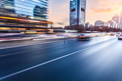 car driving on freeway at sunset, motion blur