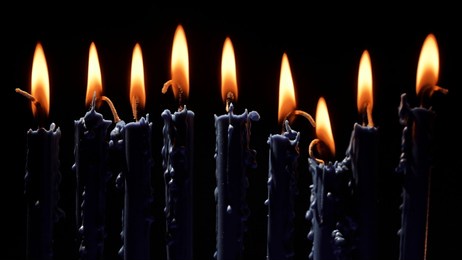 candles from a traditional menorah illuminate the darkness, creating a warm glow as the festive hanukkah celebration unfolds. symbolizing faith and heritage, the ritual honors jewish traditions.