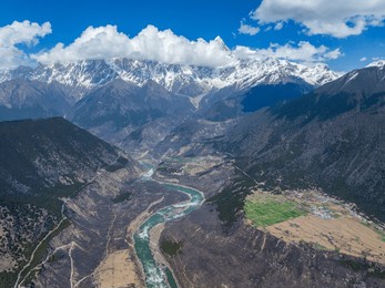 nyingchi, tibet, china - 8th april 2025 - yarlung zangbo river and high angle view of namjagbarwa peak