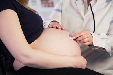 doctor examining a pregnant woman