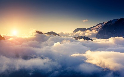 great view of the foggy val di fassa valley with pass sella. national park. dolomites (dolomiti), south tyrol. location canazei, campitello, mazzin. italy, europe. dramatic scene. beauty world.