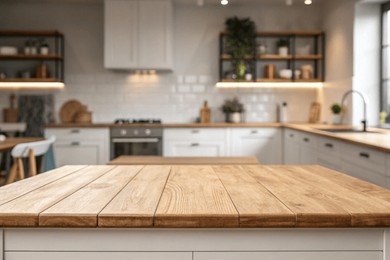wood table top on blurred kitchen background. can be used mock up for montage products display or design layout	