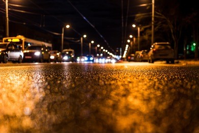 night city after rain, view of the flow of cars from the road at the asphalt
