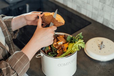 compost the kitchen waste, recycling at home. woman putting vegetables cutted leftovers into the garbage, compost bin on the table of kitchen. environmentally responsible, ecology. selective focus