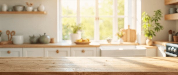 empty wooden table with the bright white interior of the kitchen as a blurred background behind the bokeh golden sunshine
