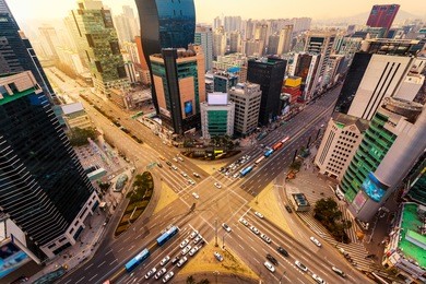 rush hour traffic zips through an intersection in the gangnam district of seoul, south korea.