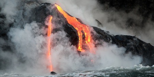 hot lava stream is flowing into the ocean. hawaii, big island.