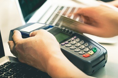 hand swiping credit card in store : still-life processed